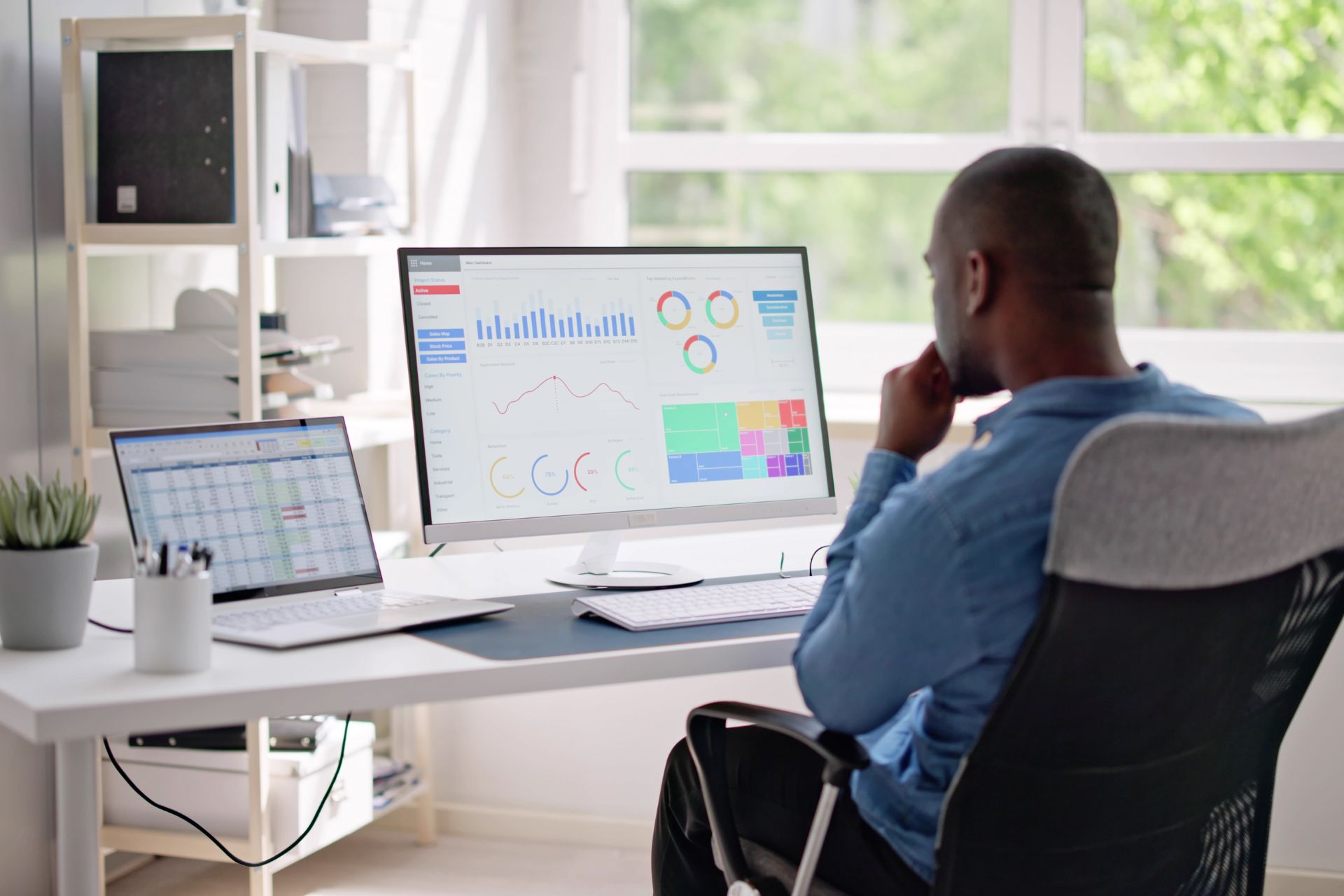 Man sitting at desk reviewing data backup Mississauga