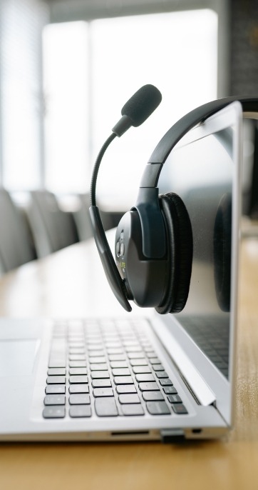 Headset resting on laptop keyboard IT support Milton