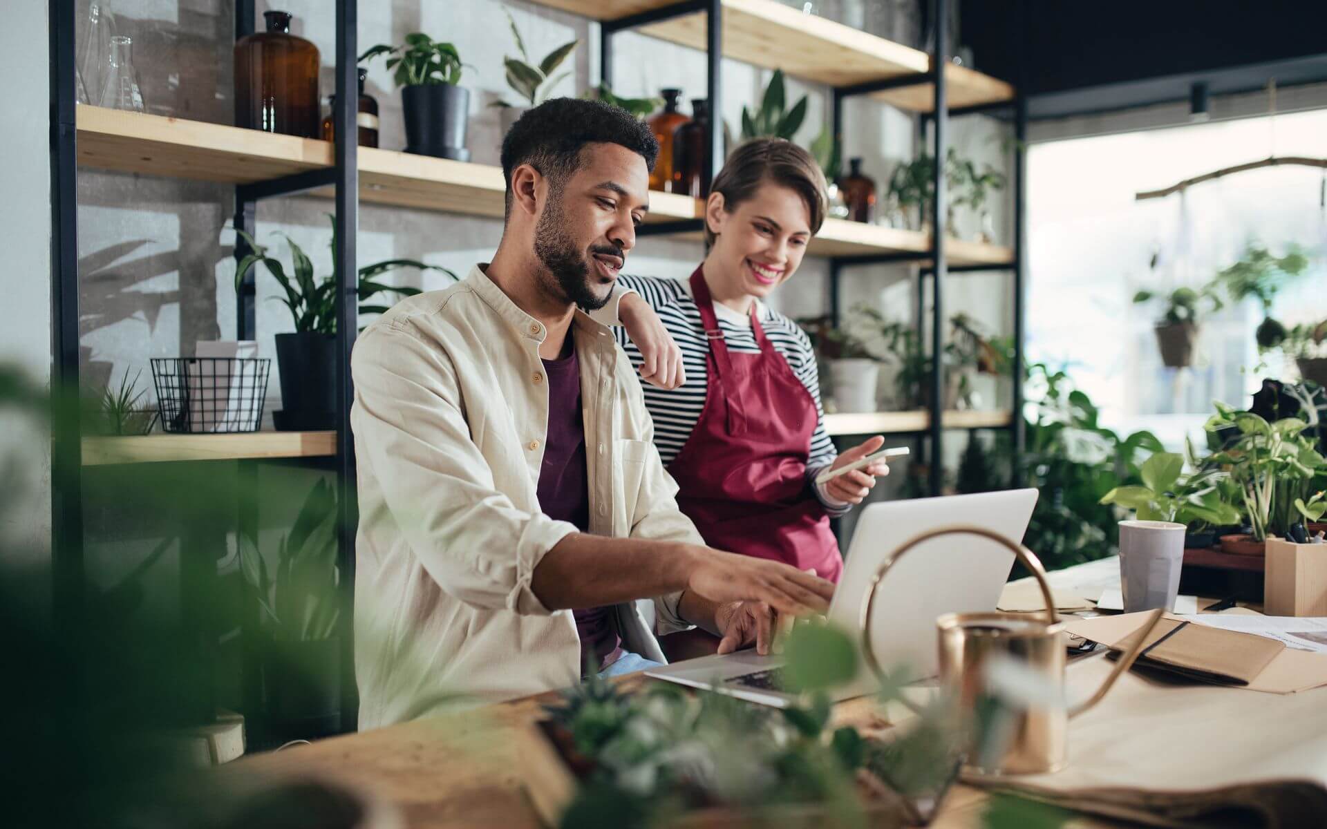 small business owners reviewing cloud security accounts in workplace