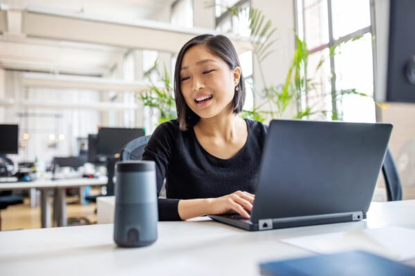 small business owner working on laptop with smart devices in the workplace